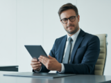Confident professional business lawyer with digital tablet in modern office environment